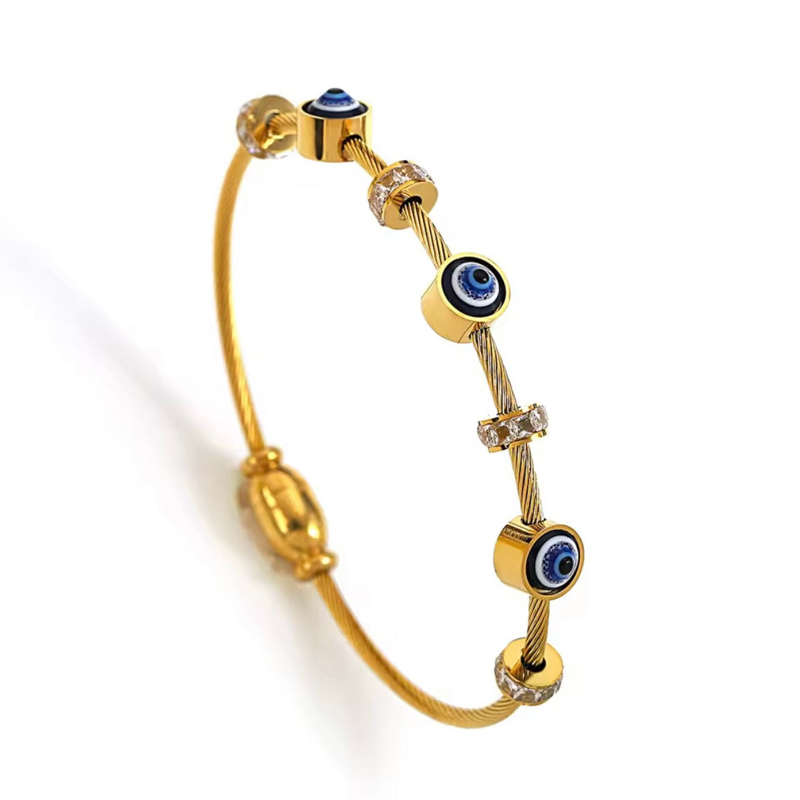 Gold bracelet with blue evil eye charms on a white background
